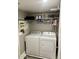 Laundry room with a washer, a dryer, and overhead storage shelves at 135 S Abalone Dr, Gilbert, AZ 85233