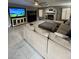 Bright living room featuring a cozy fireplace and sleek tile flooring at 135 S Abalone Dr, Gilbert, AZ 85233