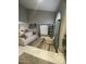 Bright living room features high ceilings, neutral tones, modern art and tile flooring at 135 S Abalone Dr, Gilbert, AZ 85233