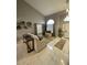 Bright living room features high ceilings, neutral tones, modern art and tile flooring at 135 S Abalone Dr, Gilbert, AZ 85233