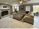 Living room featuring a cozy fireplace and sleek tile flooring at 135 S Abalone Dr, Gilbert, AZ 85233