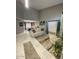 Bright living room adjacent to dining room features modern art, tile flooring, and neutral tones at 135 S Abalone Dr, Gilbert, AZ 85233