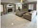 Living room featuring a cozy fireplace and sleek tile flooring at 135 S Abalone Dr, Gilbert, AZ 85233