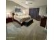 Bedroom with neutral walls and carpet, updated window treatments, a ceiling fan, and furniture at 135 S Abalone Dr, Gilbert, AZ 85233