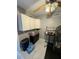 Utility room featuring upper cabinets, a small black cabinet and tile floors at 135 S Abalone Dr, Gilbert, AZ 85233