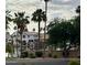 This home features a serene water view with mature landscaping and palm trees at 135 S Abalone Dr, Gilbert, AZ 85233