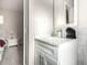 Bathroom vanity featuring white marble counters, sleek cabinets, and modern fixtures that complement the neutral tones at 1532 W Northern Ave, Phoenix, AZ 85021