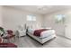 Bright bedroom with a decorative light fixture, two windows and a plush bed dressed in white linens at 1532 W Northern Ave, Phoenix, AZ 85021