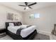Cozy bedroom with a ceiling fan, bedside table, and a guitar adding a touch of personality to the space at 1532 W Northern Ave, Phoenix, AZ 85021