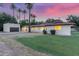 Charming single-story home with desert landscaping and a detached garage, complete with vibrant sunset backdrop at 1532 W Northern Ave, Phoenix, AZ 85021