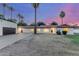 Inviting single-story home exterior with a tile roof, desert landscaping, and detached garage at 1532 W Northern Ave, Phoenix, AZ 85021