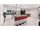 Modern kitchen with white cabinets, granite countertops, stainless steel appliances, and red bar seating at 1532 W Northern Ave, Phoenix, AZ 85021