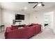 Living room with a large TV, recessed lighting, and red velvet sofa, creating a comfortable entertainment area at 1532 W Northern Ave, Phoenix, AZ 85021