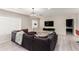 Cozy living room with a large sofa, crystal chandelier, and bright natural light from the window at 1532 W Northern Ave, Phoenix, AZ 85021