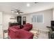 Stylish living room with a red velvet sofa, ceiling fan, and built in bar, offering a comfortable space at 1532 W Northern Ave, Phoenix, AZ 85021
