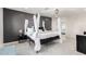 Luxurious main bedroom with a four-poster bed, accent wall, and elegant lighting at 1532 W Northern Ave, Phoenix, AZ 85021
