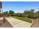 Low maintenance backyard with artificial grass, stone landscaping, and extended patio at 15422 W Ventura St, Surprise, AZ 85379