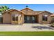 Back of house overlooking the backyard with patio and turf grass at 15422 W Ventura St, Surprise, AZ 85379