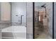 Bathroom features a tub, shower, gray tile, and a towel warmer at 15422 W Ventura St, Surprise, AZ 85379