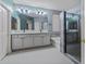Spacious bathroom with double sinks, granite countertops, and a large walk-in shower at 15422 W Ventura St, Surprise, AZ 85379