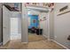 Bedroom closet featuring mirror doors, a shelf with toys, and a view of an adjacent office space at 15422 W Ventura St, Surprise, AZ 85379
