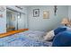 Cozy bedroom with blue accents, framed art, and mirrored closet doors, offering a comfortable retreat at 15422 W Ventura St, Surprise, AZ 85379
