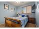 Bedroom features a bed, side table and attached TV; the floors are carpeted at 15422 W Ventura St, Surprise, AZ 85379