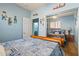 Comfortable bedroom featuring mirrored closet doors and view into the bathroom and the rest of the house at 15422 W Ventura St, Surprise, AZ 85379