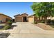 Spacious home with a three-car garage, desert landscaping, and a wide driveway at 15422 W Ventura St, Surprise, AZ 85379