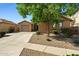 Single-story home featuring a two-car garage, desert landscaping, and a well-maintained front yard at 15422 W Ventura St, Surprise, AZ 85379