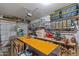 Spacious garage with shelving, work area, and garage door lift at 15422 W Ventura St, Surprise, AZ 85379