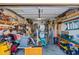 Garage with organized workspace and storage, featuring various tools and equipment at 15422 W Ventura St, Surprise, AZ 85379