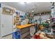 Well-organized garage workshop featuring a workbench and ample storage shelves at 15422 W Ventura St, Surprise, AZ 85379
