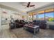 Living room with leather sofas and a view into the open concept kitchen featuring an airy and open floor plan at 15422 W Ventura St, Surprise, AZ 85379