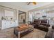 Living room featuring dark leather sofas, wood flooring, built-in media center and open floor plan concept at 15422 W Ventura St, Surprise, AZ 85379