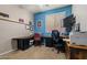 Office space features two work stations, shelving, and a chair, with neutral carpeting at 15422 W Ventura St, Surprise, AZ 85379