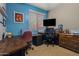 Functional home office with two desks, a large window, and neutral colors, ideal for productivity at 15422 W Ventura St, Surprise, AZ 85379
