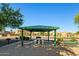 Shaded picnic area with a table, benches, and barbecue grills, perfect for outdoor gatherings at 15422 W Ventura St, Surprise, AZ 85379
