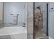 Modern bathroom showing tile enclosed shower and separate soaking tub at 15422 W Ventura St, Surprise, AZ 85379