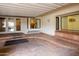 An outdoor patio area with tile flooring, large windows, and access to the backyard at 1550 N Stapley Dr # 6, Mesa, AZ 85203