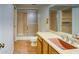 Bathroom offers a single vanity sink and shower with a glass door, providing functionality at 1550 N Stapley Dr # 6, Mesa, AZ 85203