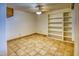 Inviting bedroom with ample natural light, tile flooring, ceiling fan, and shelving units at 1550 N Stapley Dr # 6, Mesa, AZ 85203