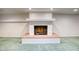Basement with a brick fireplace set upon a raised brick platform and simple white mantel at 1550 N Stapley Dr # 6, Mesa, AZ 85203
