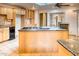 Spacious kitchen with a large island, granite countertops, and stainless steel appliances at 1550 N Stapley Dr # 6, Mesa, AZ 85203