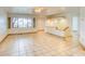 Open living room with tile floors, neutral walls, a ceiling fan, and picture window at 1550 N Stapley Dr # 6, Mesa, AZ 85203
