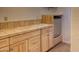 Charming wet bar features a sink with a tile backsplash and a mini-fridge for added convenience at 1550 N Stapley Dr # 6, Mesa, AZ 85203