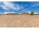 View of a vacant lot and house at 16415 W Oyer Ln, Surprise, AZ 85387