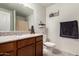 Bathroom features a granite countertop vanity, mirror, tile flooring and bath-shower combo at 16415 W Oyer Ln, Surprise, AZ 85387