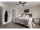 Comfortable bedroom, with soft neutral color palette, showcases a clothing rack and carpet flooring at 16415 W Oyer Ln, Surprise, AZ 85387