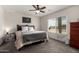 Cozy bedroom showcasing a comfortable bed, neutral color palette, and a bright window view at 16415 W Oyer Ln, Surprise, AZ 85387
